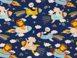 Playful fabric pattern with lions, pandas, and elephants riding colorful rockets through clouds, stars, and rainbows on a navy blue background.