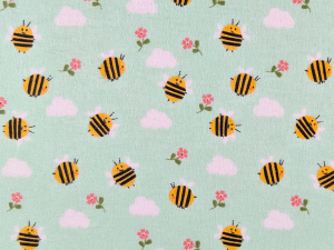 Repeating pattern of yellow and black bees, pink clouds, and pink flowers on a mint-green background.