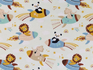 Playful fabric pattern with lions, elephants, and pandas riding colorful rockets among stars and rainbows.